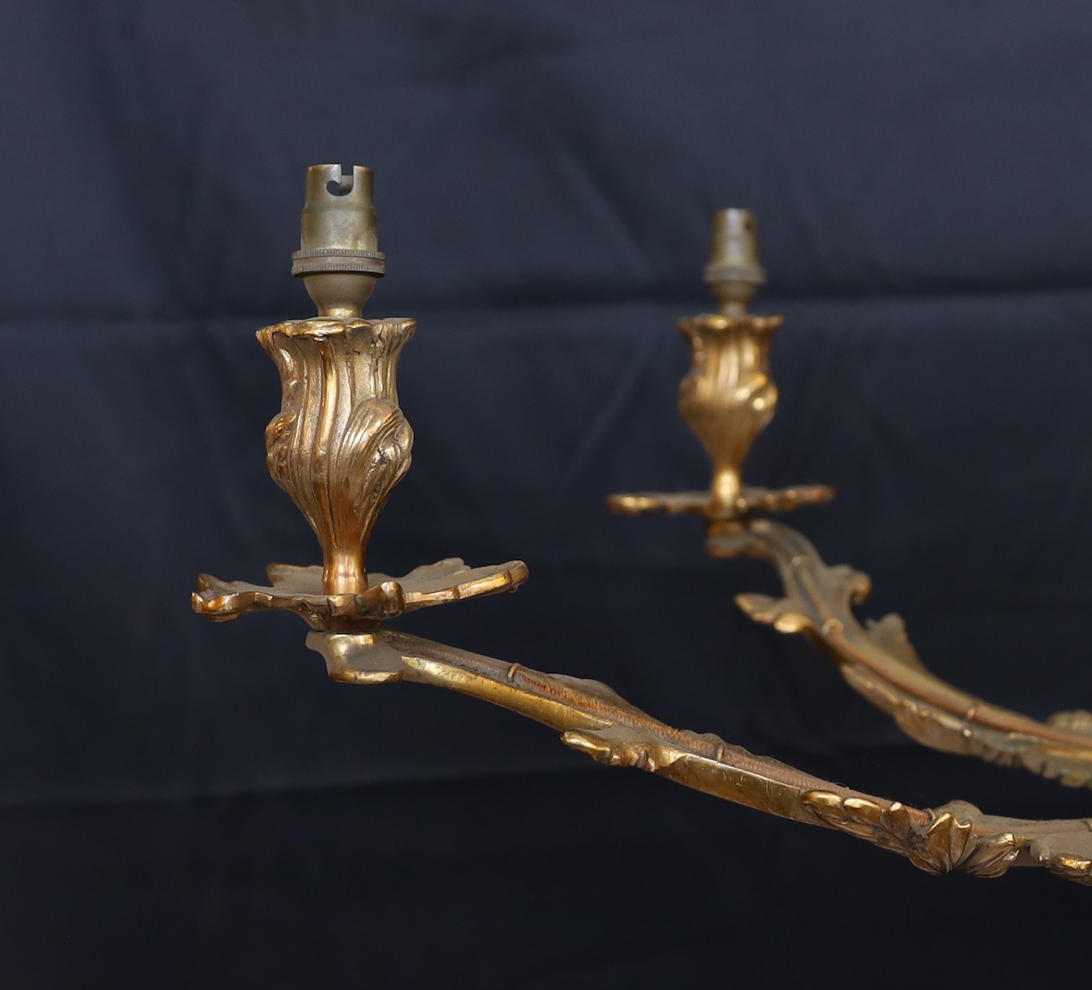 An early 20th century French gilt bronze rococo six light chandelier, height 59cm. width 66cm